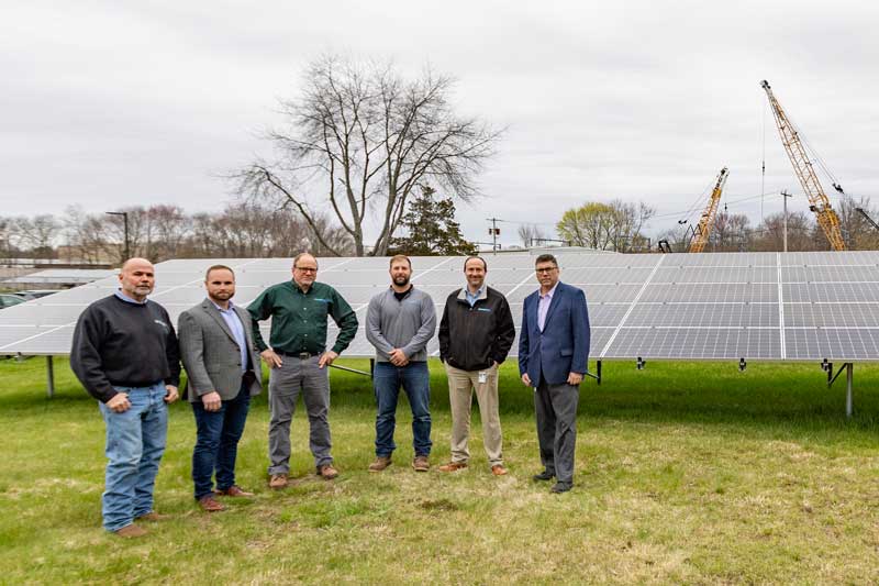 From left - John Smith and CEO Sam Schneider from Earthlight Technologies stand with Jim Casagrande, Colin Steele, Dave Peeling and Craig Patla from Connecticut Water near the solar installation at the water company's Clinton office.