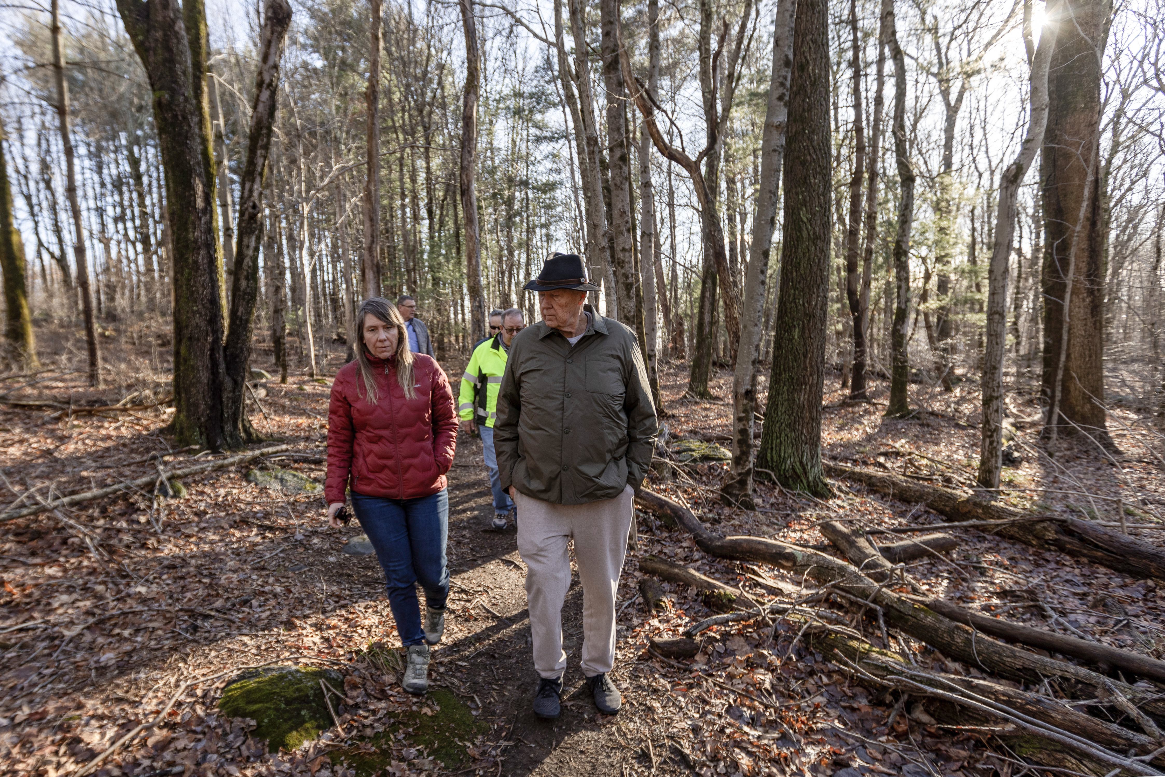 Naugatuck Mayor Pete Hess walks with Connecticut Water staff while discussing plans to develop a formal trail on a parcel the borough recently purchased from Connecticut Water.