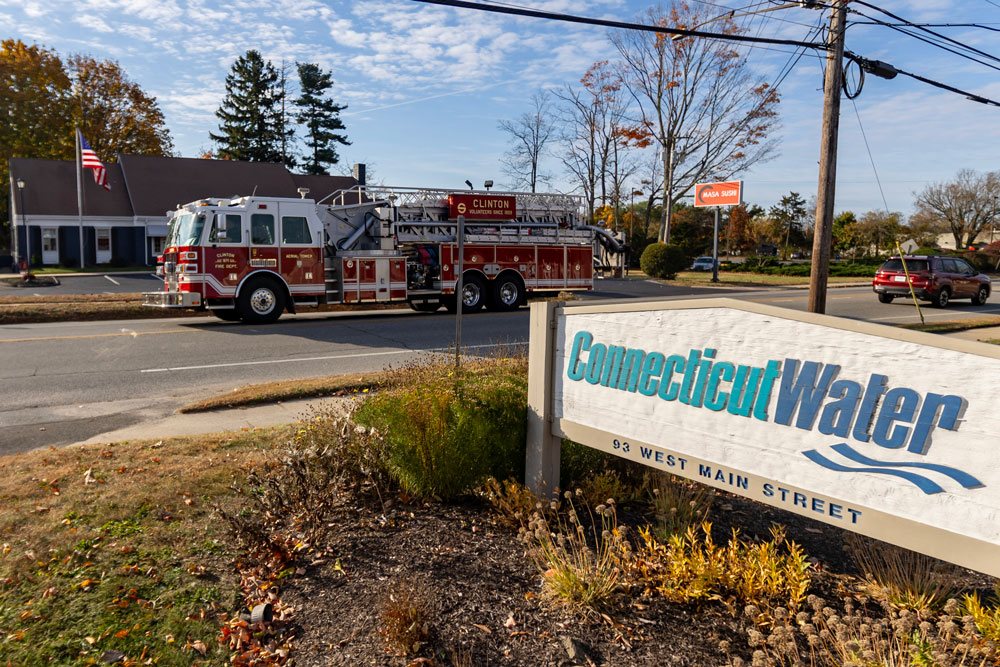 A fire truck passes by the Connecticut Water sign in Clinton, Conn.