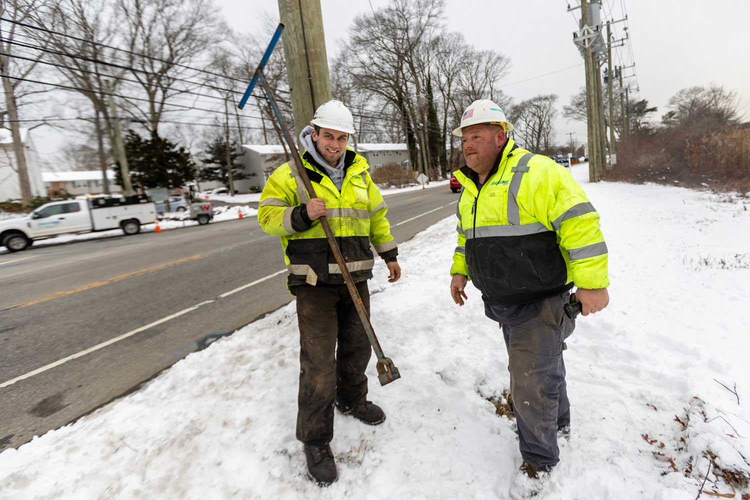 Connecticut Water employees walking through snow to fix a leak