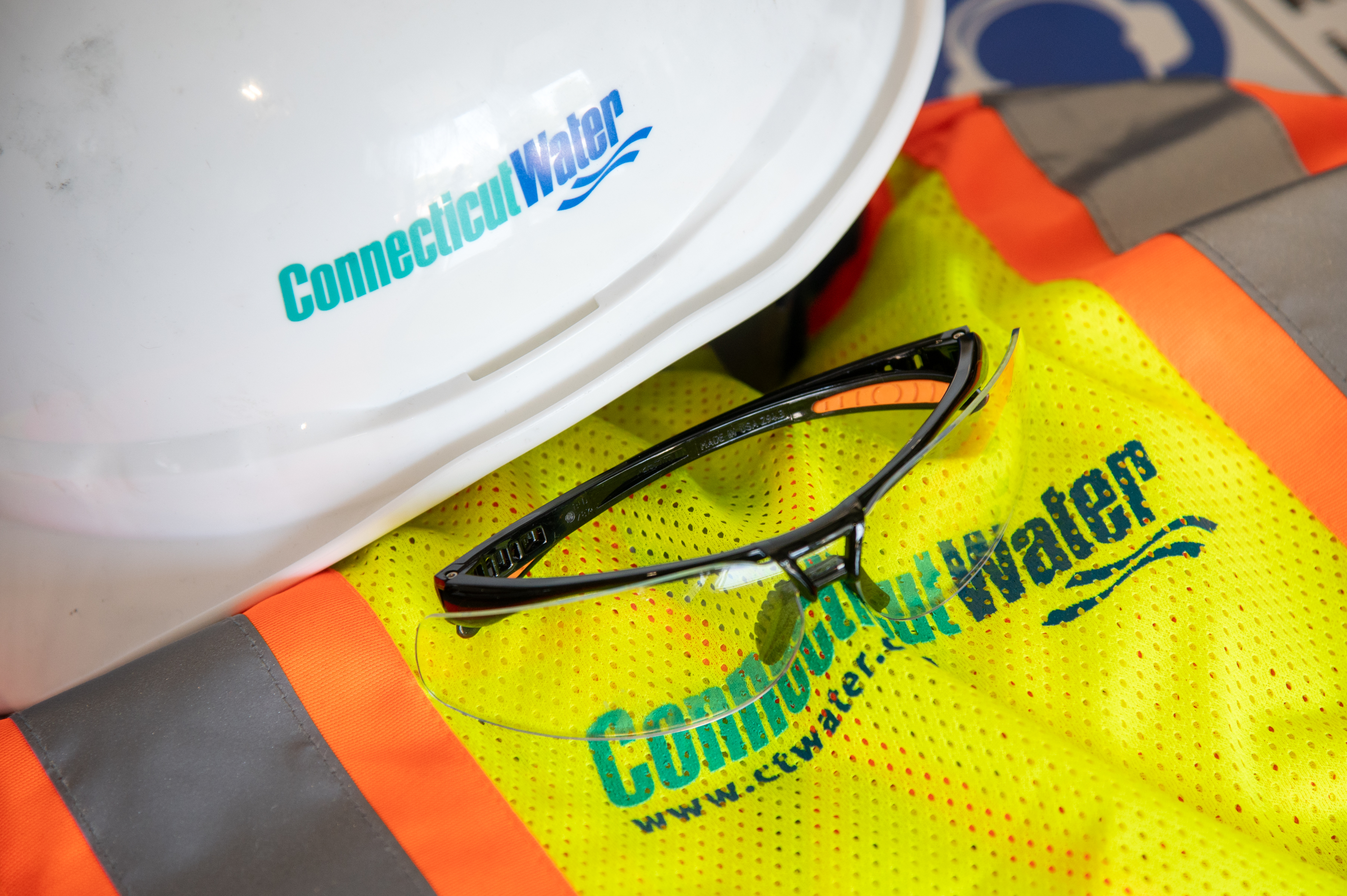 hard hat, safety glasses and vest with with the Connecticut Water logo