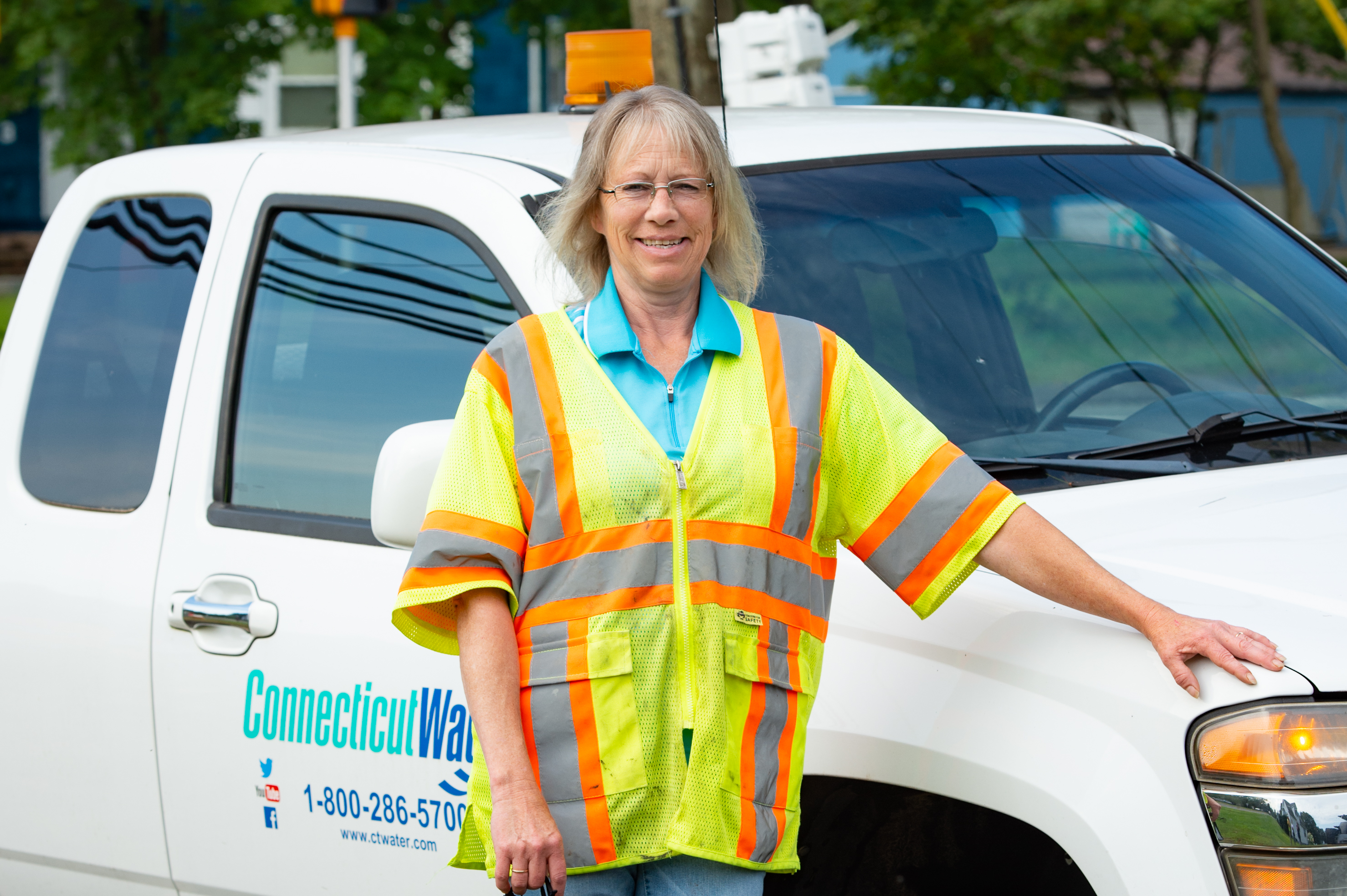 Connecticut Water employee standing in front of a service truck 